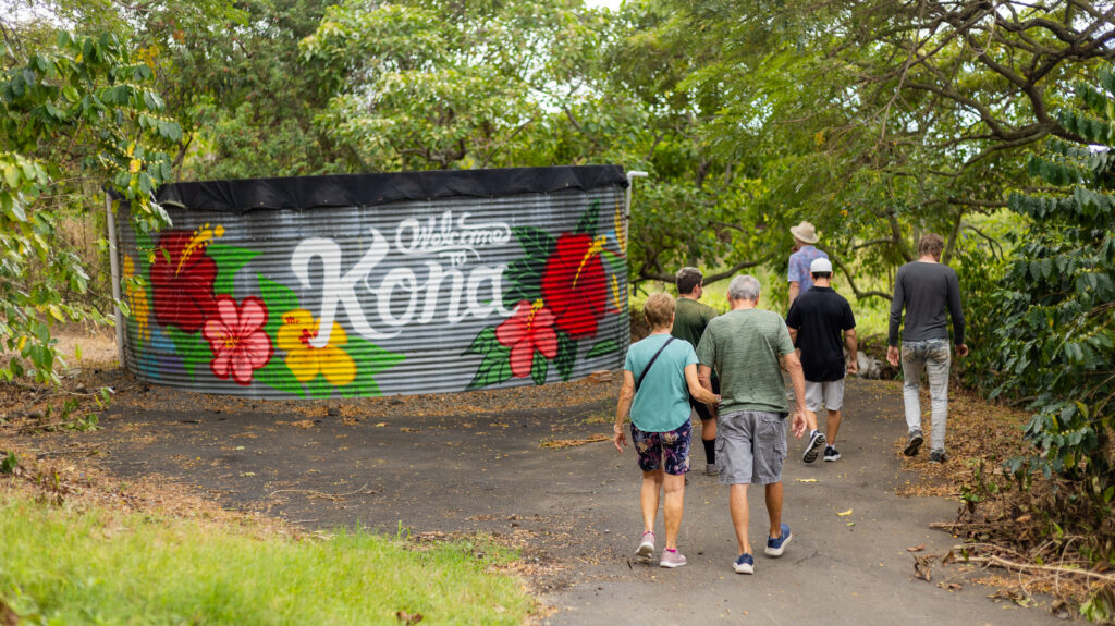 Walking by Welcome to Kona Sign